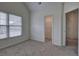 Bright carpeted bedroom with a closet and double window that provides great natural light at 233 Yorkshire Ln, Villa Rica, GA 30180