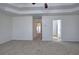 A spacious bedroom features neutral carpet, a tray ceiling, and ample natural light at 233 Yorkshire Ln, Villa Rica, GA 30180
