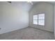 A carpeted bedroom with vaulted ceilings and bright natural light from the double window at 233 Yorkshire Ln, Villa Rica, GA 30180