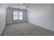 A bedroom with light walls, carpet flooring, and a ceiling fan for climate control at 233 Yorkshire Ln, Villa Rica, GA 30180