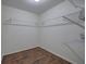 Walk-in closet features wood flooring, built-in shelving and ample storage space at 233 Yorkshire Ln, Villa Rica, GA 30180