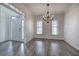 Elegant dining room with a modern chandelier, hardwood floors, and natural light at 233 Yorkshire Ln, Villa Rica, GA 30180