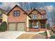 Charming brick two-story home with a two-car garage and covered front porch at 233 Yorkshire Ln, Villa Rica, GA 30180
