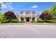 Inviting clubhouse featuring a covered porch, black shutters and lush landscaping creates an idyllic community gathering place at 233 Yorkshire Ln, Villa Rica, GA 30180