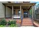 Inviting front porch with a cozy swing, brick steps, and a secure Vivint security system at 233 Yorkshire Ln, Villa Rica, GA 30180