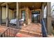Inviting front porch featuring stone accents, hanging lights, and a cozy porch swing at 233 Yorkshire Ln, Villa Rica, GA 30180