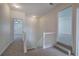 Carpeted hallway leading to bedrooms, naturally lit by a light fixture and side facing windows at 233 Yorkshire Ln, Villa Rica, GA 30180