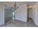 Open hallway and dining room featuring elegant chandelier and neutral tones at 233 Yorkshire Ln, Villa Rica, GA 30180