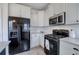 Spacious kitchen featuring stainless steel appliances, granite counters, and ample cabinet space at 233 Yorkshire Ln, Villa Rica, GA 30180