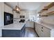 Bright kitchen featuring stone countertops, stainless appliances, and a stylish island with wooden shelves at 233 Yorkshire Ln, Villa Rica, GA 30180