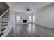 Spacious living room with a fireplace, hardwood floors, and natural light from large windows at 233 Yorkshire Ln, Villa Rica, GA 30180