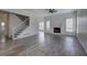 Bright living room featuring hardwood floors, a fireplace, and an open floor plan with stairs at 233 Yorkshire Ln, Villa Rica, GA 30180