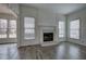 Bright living room with a fireplace, hardwood floors, and large windows, perfect for relaxing and entertaining at 233 Yorkshire Ln, Villa Rica, GA 30180