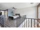 Modern bedroom loft featuring wood floors, a ceiling fan, and a stylish black metal railing at 322 Peters Sw St # 6, Atlanta, GA 30313