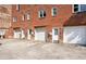 Back of building with multiple garages and entries on a concrete parking pad at 322 Peters Sw St # 6, Atlanta, GA 30313