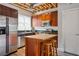 Modern kitchen with stainless steel appliances, an island with bar seating, and wooden cabinetry at 322 Peters Sw St # 6, Atlanta, GA 30313