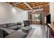 Spacious living room featuring exposed brick, wooden floors and modern furniture at 322 Peters Sw St # 6, Atlanta, GA 30313
