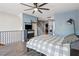 Bright main bedroom features a ceiling fan, accent wall, and staircase access at 322 Peters Sw St # 6, Atlanta, GA 30313