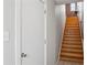 Interior wooden stairway with a white door at the bottom and window at top at 322 Peters Sw St # 6, Atlanta, GA 30313