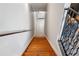 Interior stairway featuring hardwood steps, railing, and freshly painted walls at 322 Peters Sw St # 6, Atlanta, GA 30313