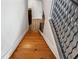 Wooden stairway descending, featuring a unique metal railing and hardwood floors at 322 Peters Sw St # 6, Atlanta, GA 30313