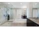 Well-lit bathroom with dual sinks, soaking tub, and glass shower at 3325 Piedmont Ne Rd # 3005, Atlanta, GA 30305