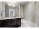 Luxurious bathroom featuring sleek dark wood cabinets, marble countertop, and a relaxing soaking tub at 3325 Piedmont Ne Rd # 3005, Atlanta, GA 30305