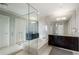 Bathroom featuring dual vanities, soaking tub, and glass shower at 3325 Piedmont Ne Rd # 3005, Atlanta, GA 30305