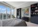 Bedroom with city views, modern decor, and stylish built-in bookcases at 3325 Piedmont Ne Rd # 3005, Atlanta, GA 30305
