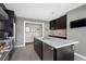 Contemporary kitchen featuring dark cabinetry, stainless appliances, a center island, and modern fixtures at 3325 Piedmont Ne Rd # 3005, Atlanta, GA 30305