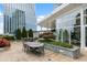 Condo lounge with outdoor dining table, chairs, and lush landscaping at 3325 Piedmont Ne Rd # 3005, Atlanta, GA 30305