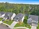 Aerial shot of a well-maintained home with a dark gray roof, green lawn, and a community lake backdrop at 411 Riverclub Rd, Acworth, GA 30101
