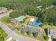 Aerial view of a neighborhood pool, basketball court, volleyball court, parking area, and community building at 411 Riverclub Rd, Acworth, GA 30101