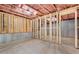 Unfinished basement with concrete walls, exposed framing, and visible wiring, offering customization potential at 411 Riverclub Rd, Acworth, GA 30101