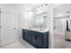 Modern bathroom featuring a double sink vanity and a large mirror at 411 Riverclub Rd, Acworth, GA 30101