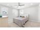 Bright bedroom with neutral decor, ceiling fan, and ample natural light from two windows at 411 Riverclub Rd, Acworth, GA 30101