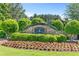 Community entrance sign with lush green landscaping and flowers at 411 Riverclub Rd, Acworth, GA 30101