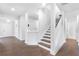 Entryway featuring hardwood floors and a staircase with white railings at 411 Riverclub Rd, Acworth, GA 30101