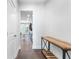 Bright hallway with hardwood floors, a stylish console table, and a view into the modern kitchen at 411 Riverclub Rd, Acworth, GA 30101