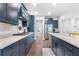 Well-appointed kitchen with granite countertops, stainless steel appliances, and elegant dark blue cabinetry at 411 Riverclub Rd, Acworth, GA 30101