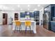 Modern kitchen with a large island, stylish seating, stainless steel appliances, and dark blue cabinetry at 411 Riverclub Rd, Acworth, GA 30101