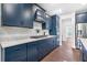 Well-appointed kitchen with granite countertops, stainless steel appliances, and elegant dark blue cabinetry at 411 Riverclub Rd, Acworth, GA 30101