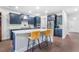 Modern kitchen with a large island, stylish seating, stainless steel appliances, and dark blue cabinetry at 411 Riverclub Rd, Acworth, GA 30101