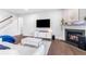 Inviting living room featuring a fireplace, hardwood floors, and a comfortable seating area, perfect for relaxation at 411 Riverclub Rd, Acworth, GA 30101