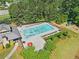 Aerial view of a neighborhood pool, chairs, playground, and community building at 411 Riverclub Rd, Acworth, GA 30101