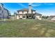 A spacious backyard featuring a well-maintained lawn and an outdoor seating area with blue curtains at 4575 Birch Way, Loganville, GA 30052