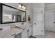 Bright bathroom featuring a vanity with white cabinets and black hardware and tile flooring at 4575 Birch Way, Loganville, GA 30052