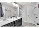 Stylish bathroom featuring double vanity with dark cabinets, bright lighting and tile floors at 4575 Birch Way, Loganville, GA 30052