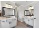Bright bathroom with a dual sink vanity and a makeup vanity with two large mirrors at 4575 Birch Way, Loganville, GA 30052