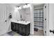Bathroom with double sinks, white countertops, and a shower/tub combo at 4575 Birch Way, Loganville, GA 30052